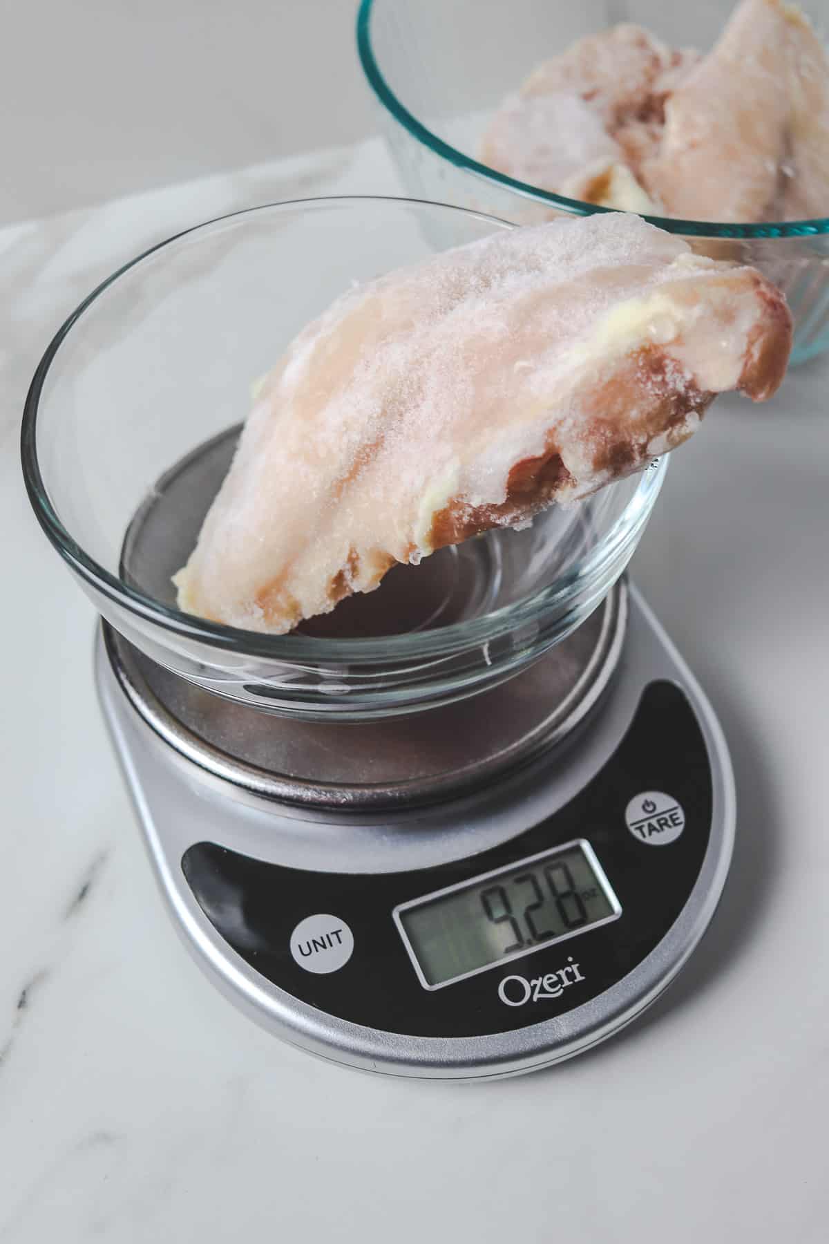 weighing out a frozen chicken breast
