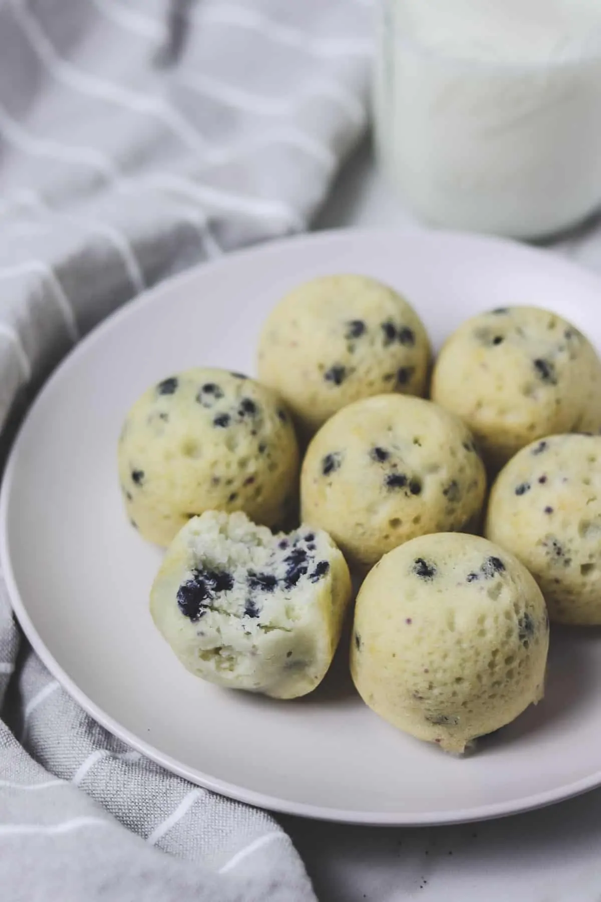 muffin bites with a bite taken out on a white plate