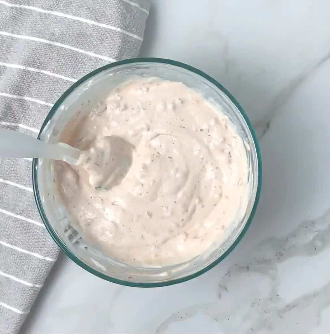 mixing salsa ranch dressing in a glass mixing bowl