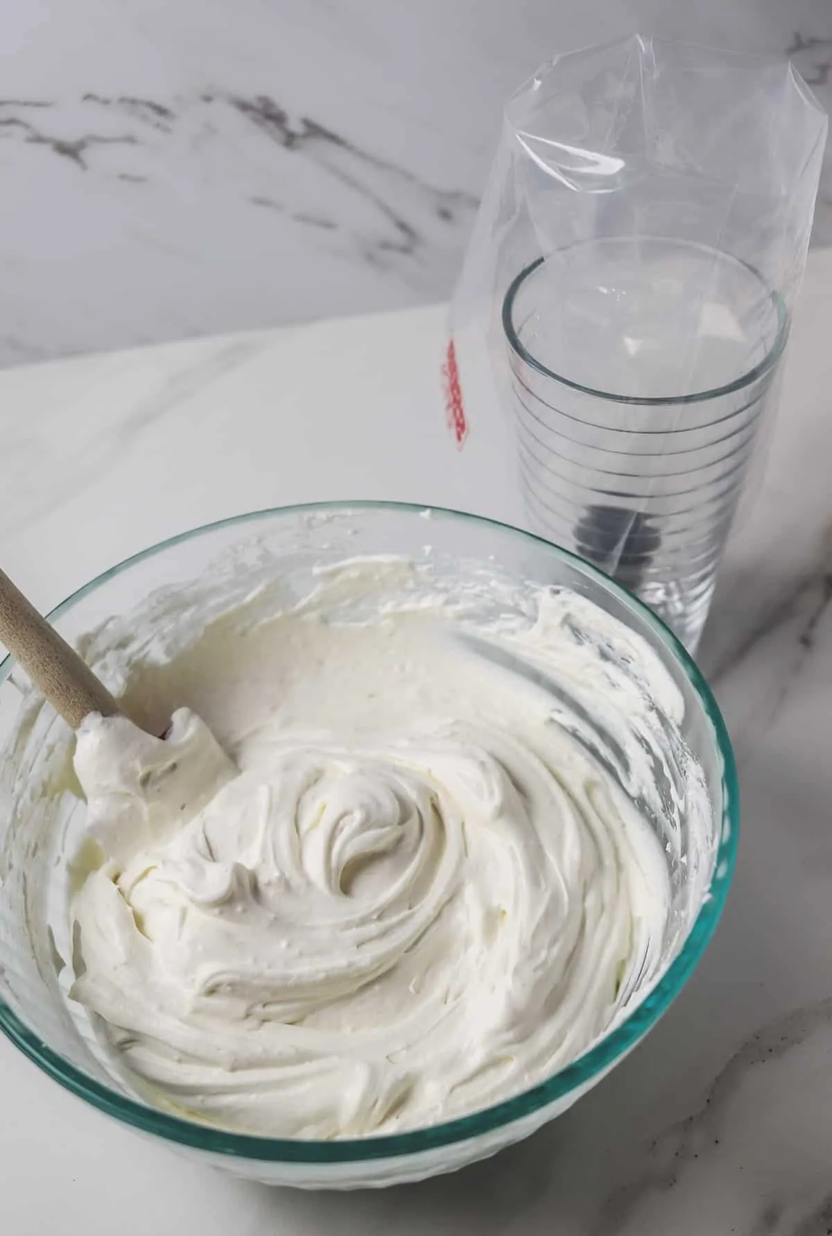 sugar-free frosting in mixing bowl with prepared piping bag