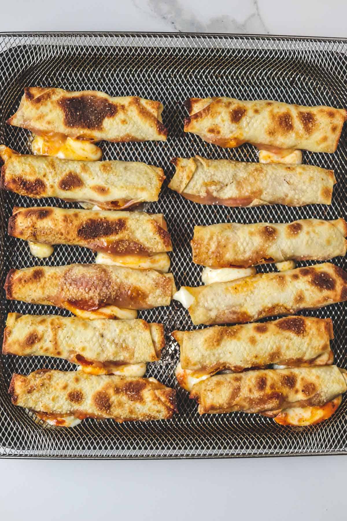 cooked pizza rolls in air fryer basket