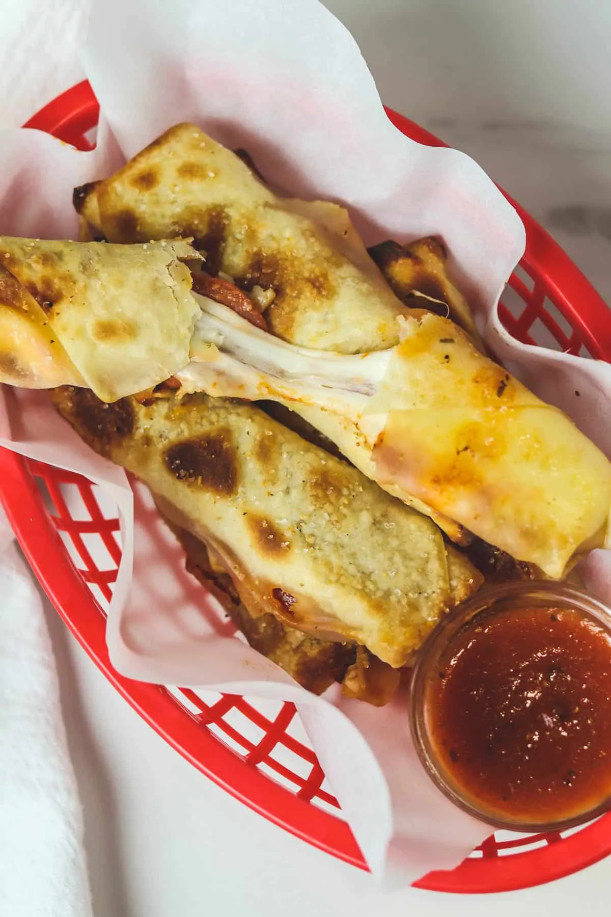 air fryer pizza rolls in a red basket