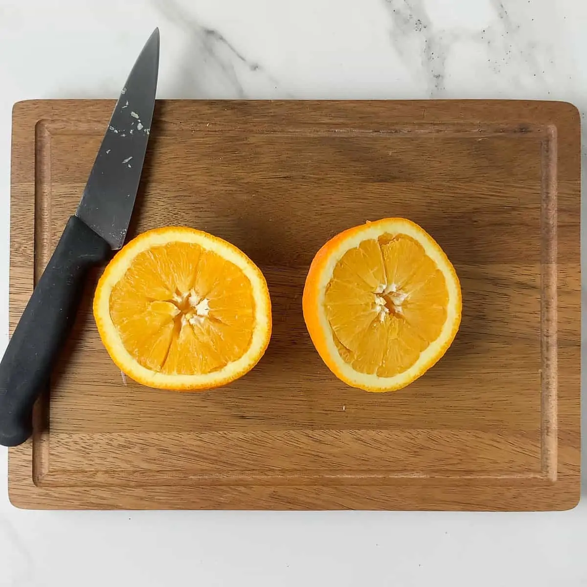 navel orange halves sliced into wedges on cutting board