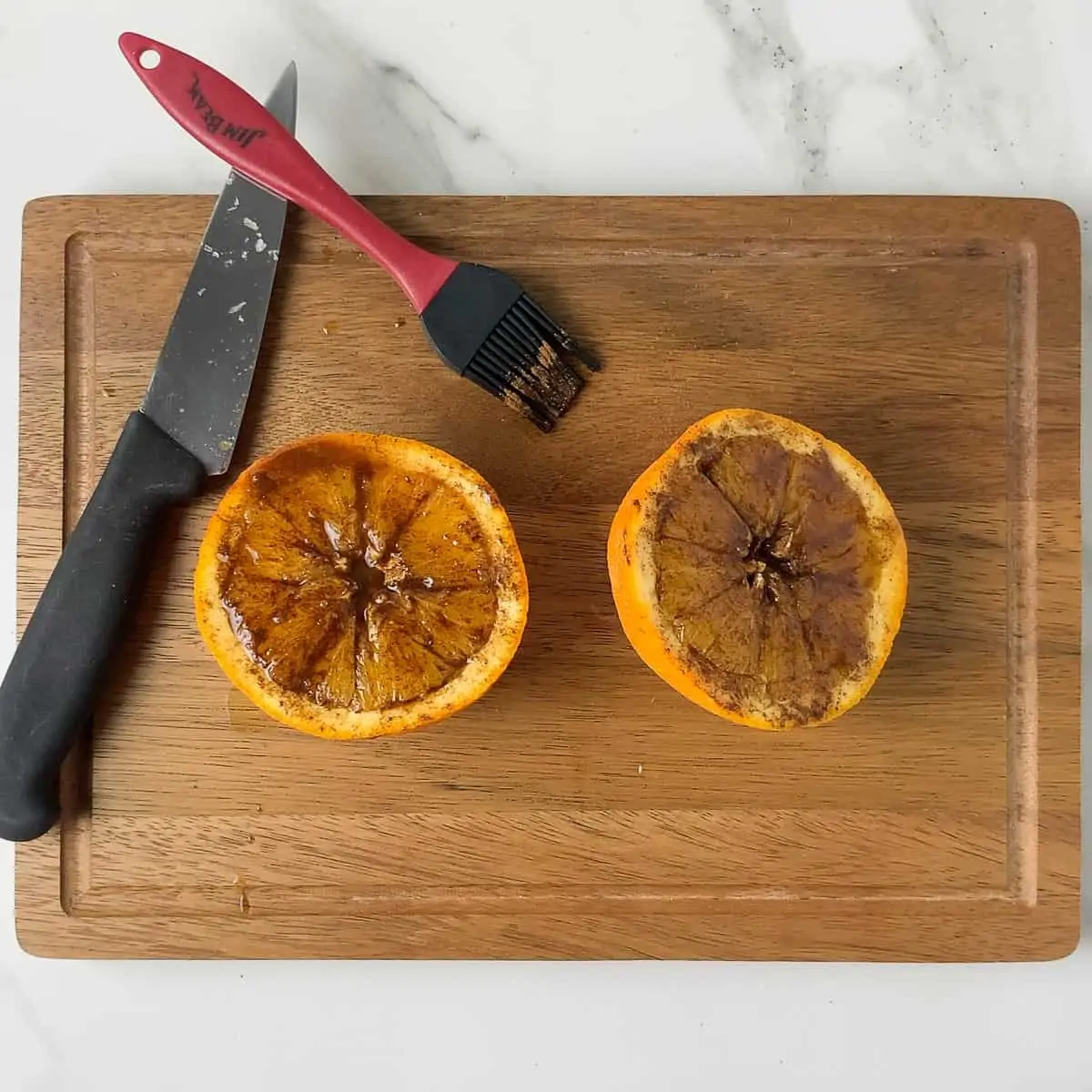 orange halves brushed with cinnamon, honey, and vanilla on cutting boards