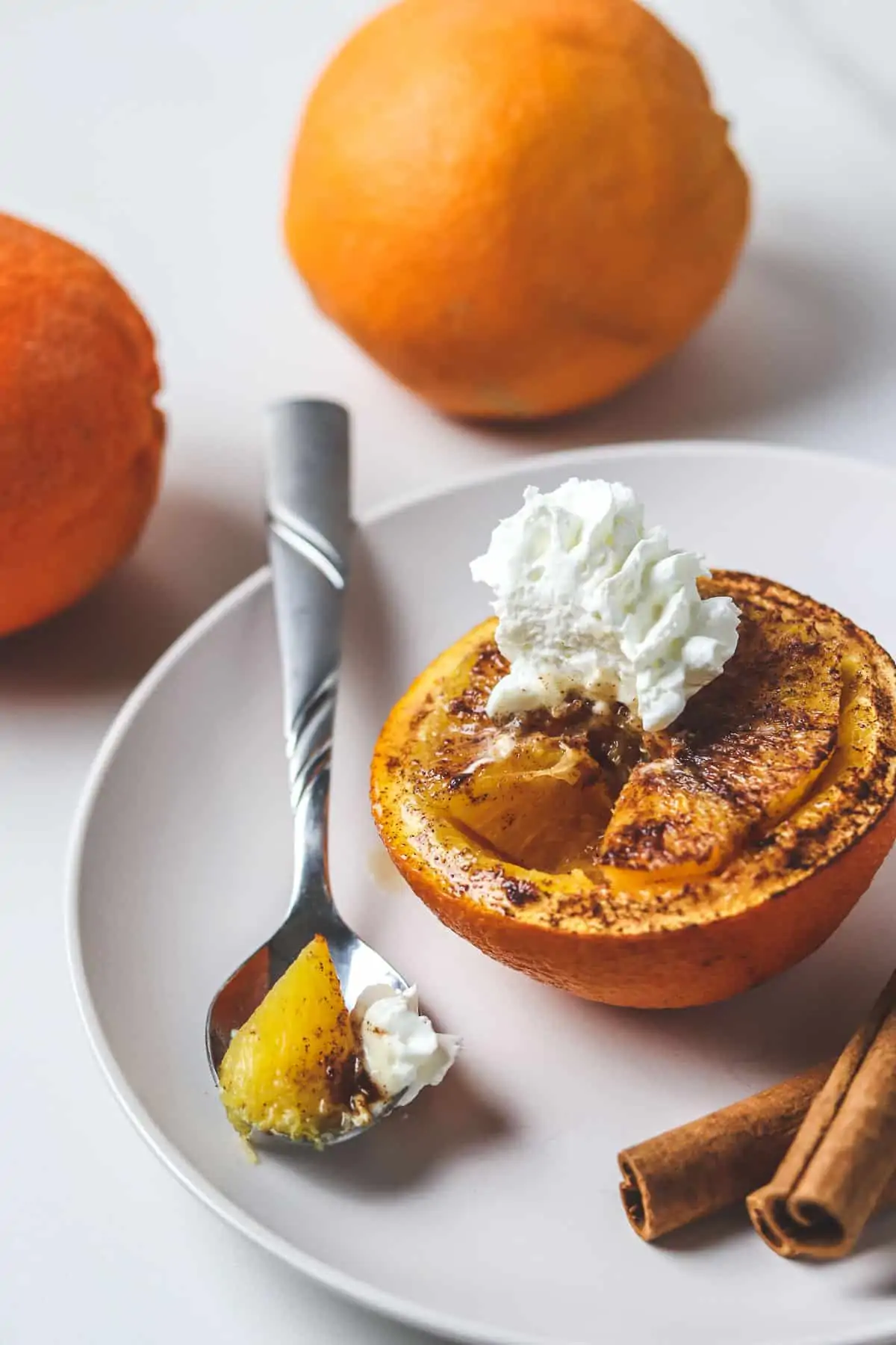 baked orange topped with whipped cream