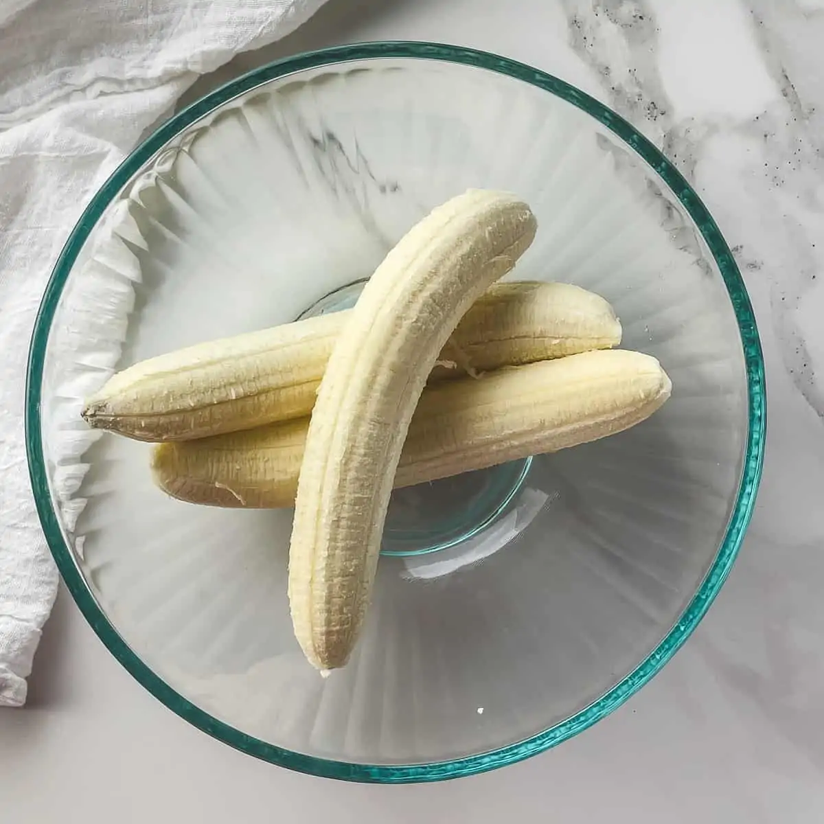 whole peeled bananas in a mixing bowl