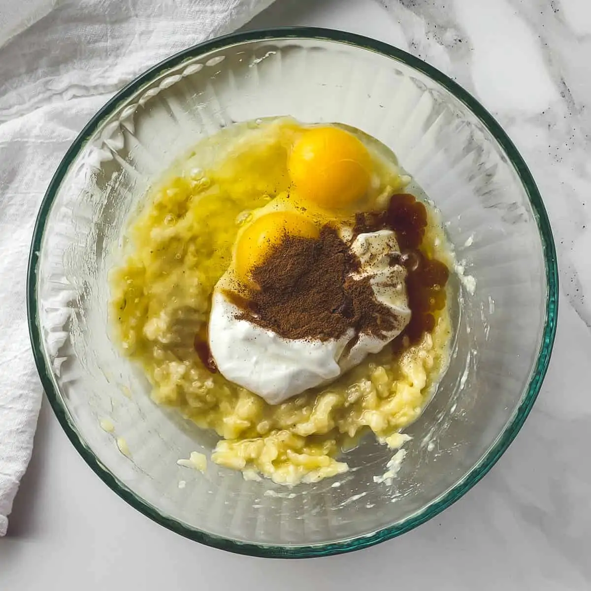 ingredients for banana bread batter in a mixing bowl