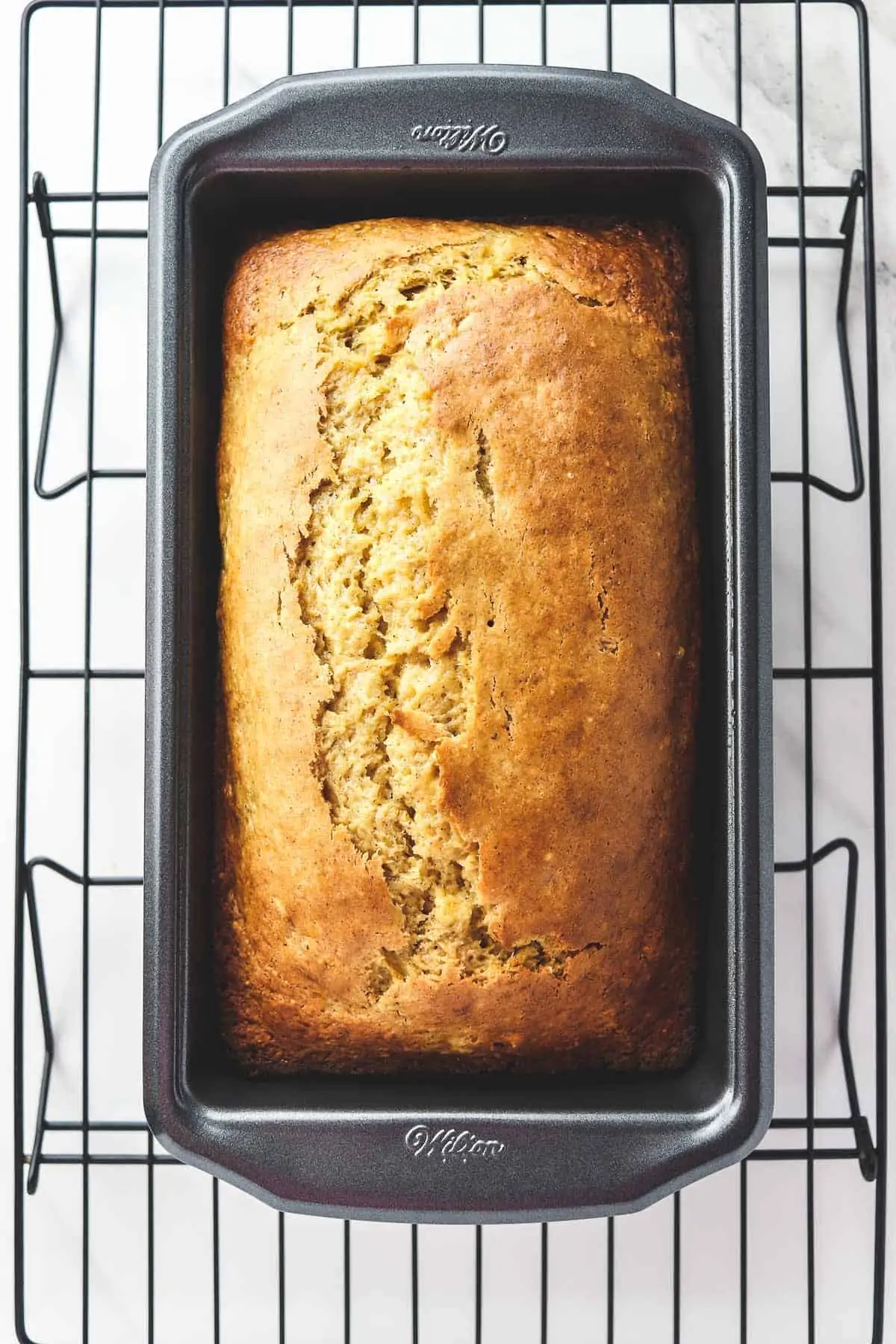 cooked banana bread cooling in a loaf pan