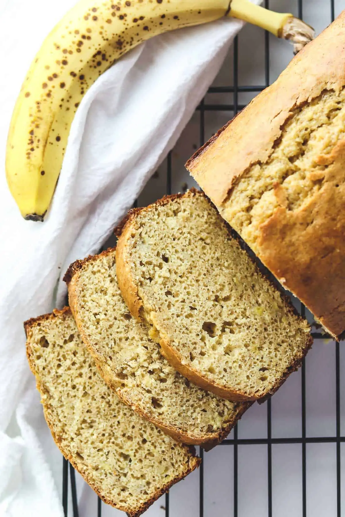 low calorie banana bread cut into slices on a coolign rack