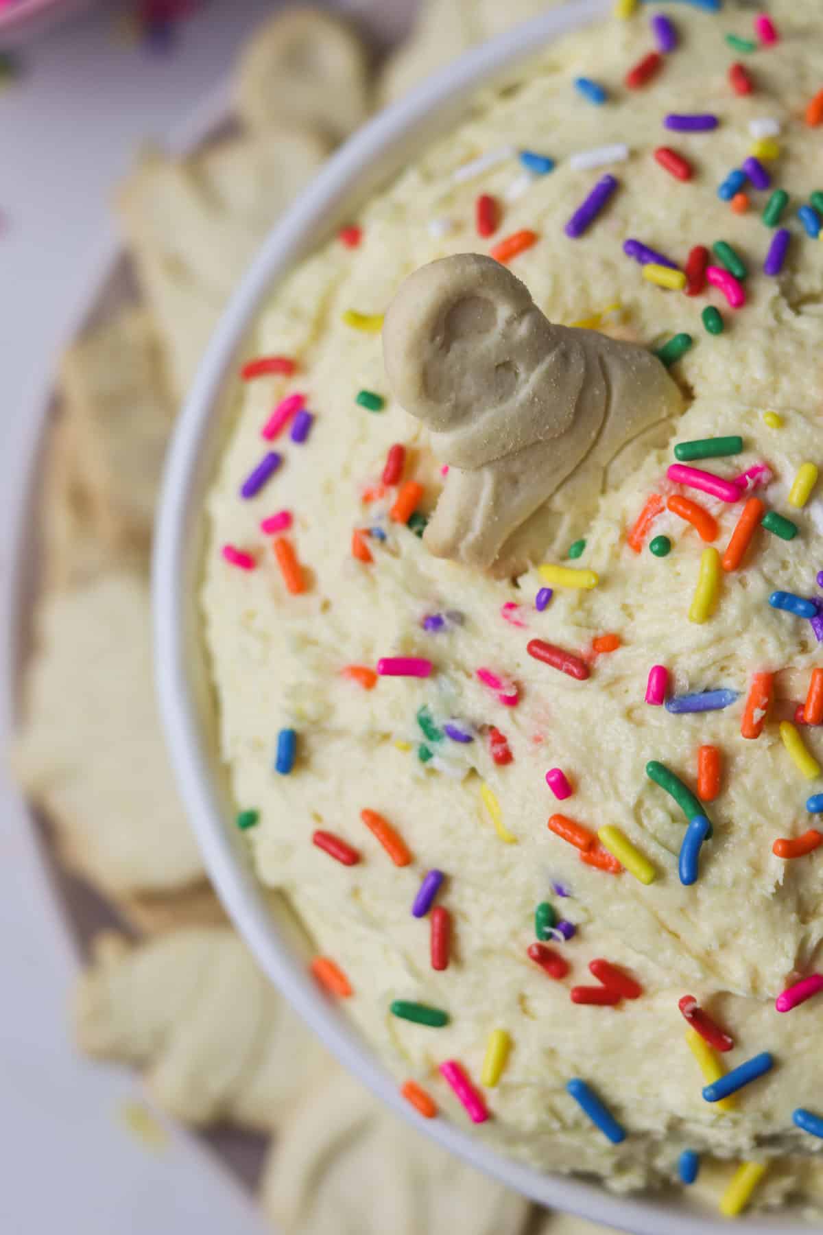 bowl of dunkaroo dip with sprinkles and animal crackers