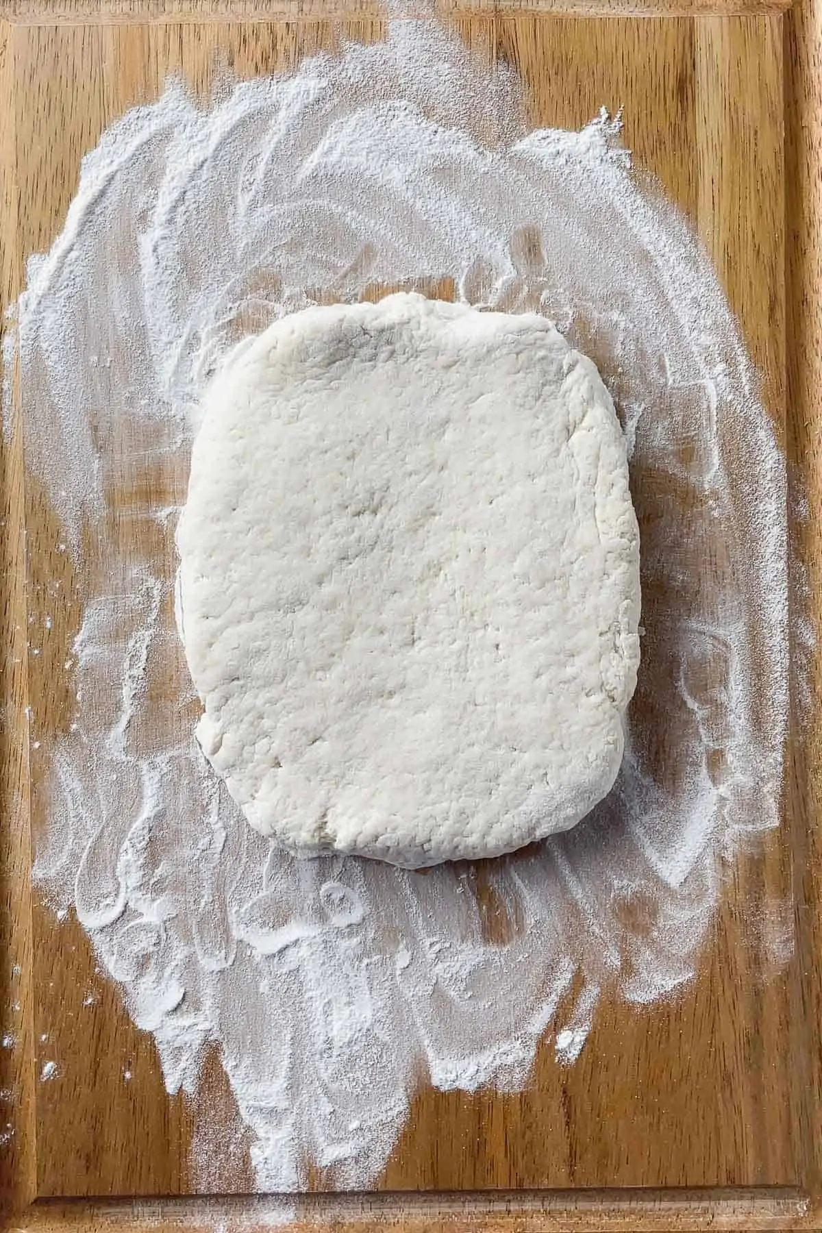 biscuit dough rolled into a rectangle on a cutting board