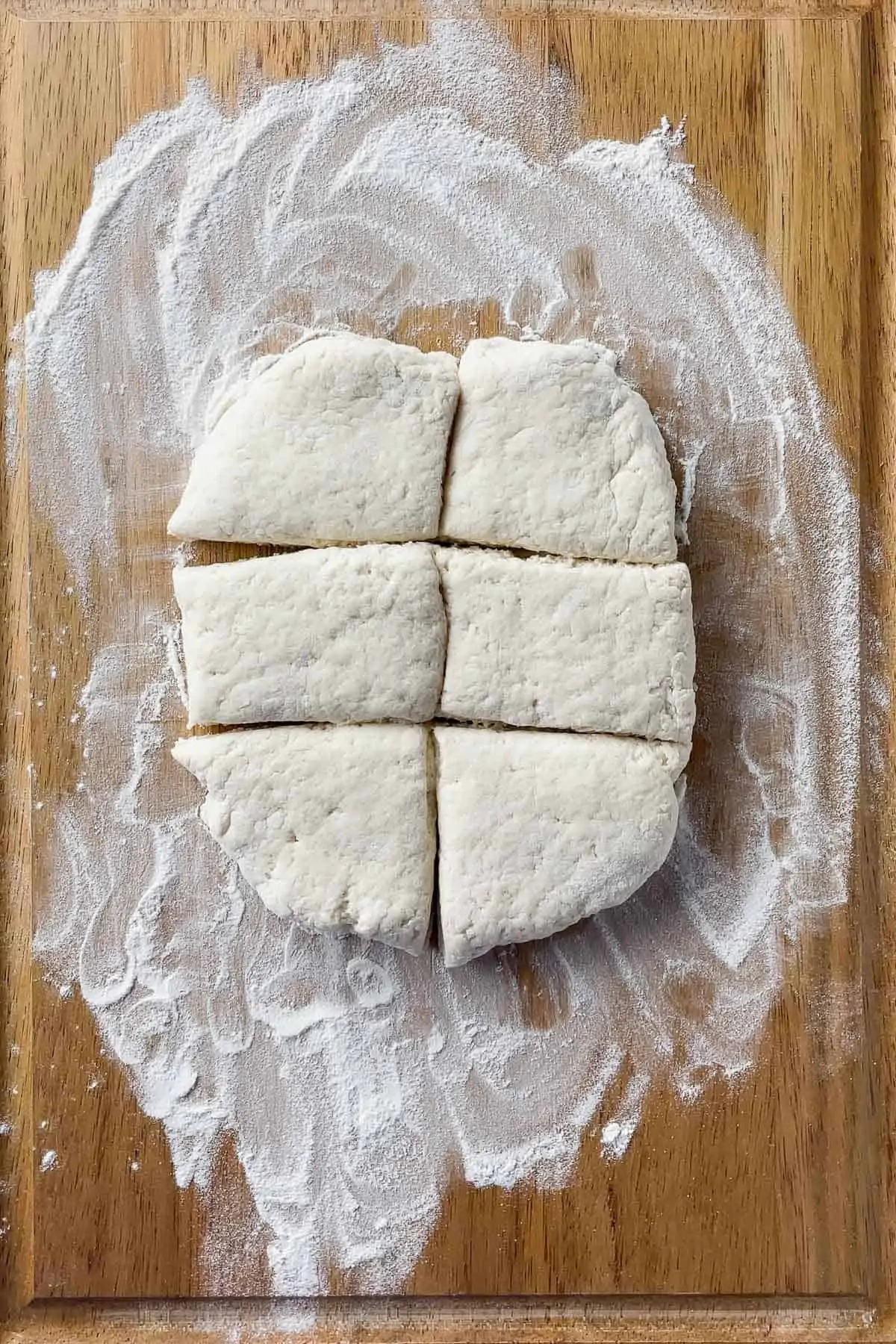 biscuit dough cut into 6 pieces on a cutting board