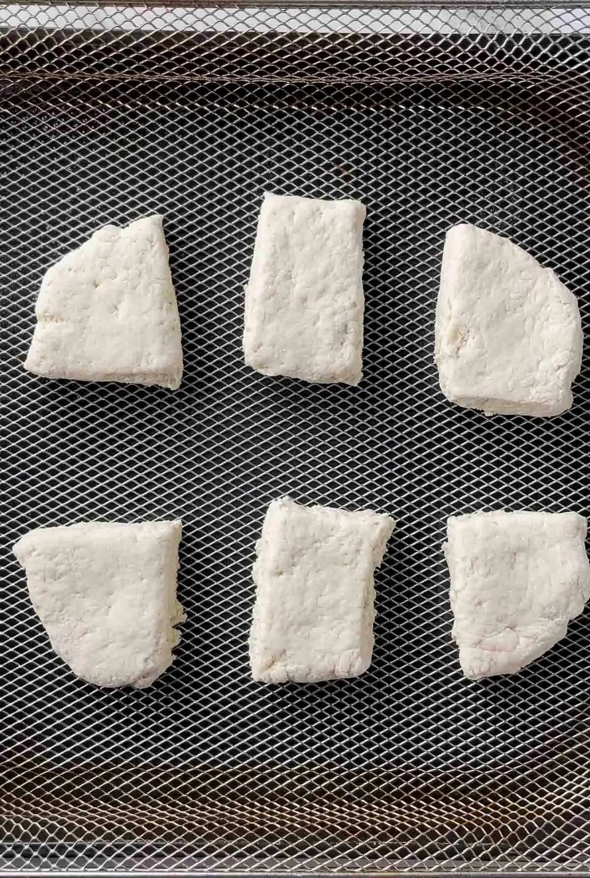 uncooked biscuits in air fryer basket