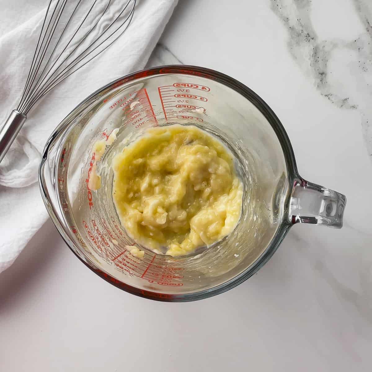 mashed banana in a measuring cup
