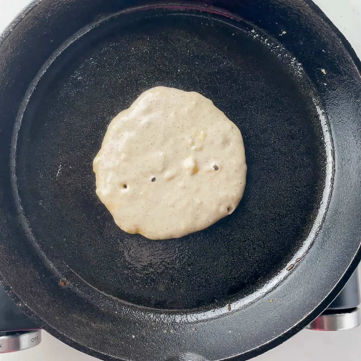 cooking a pancake on a cast iron skillet