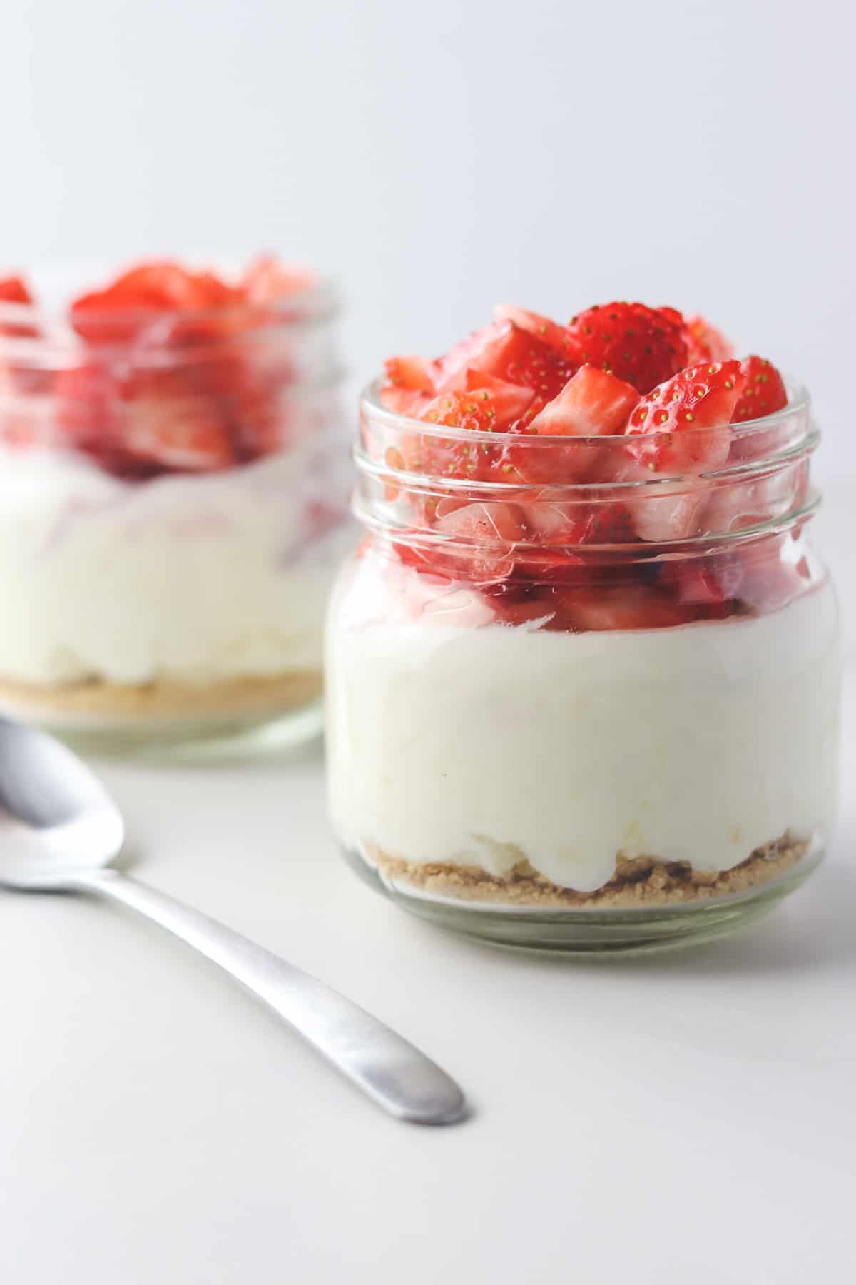 two jars of skinny cheesecake with a spoon