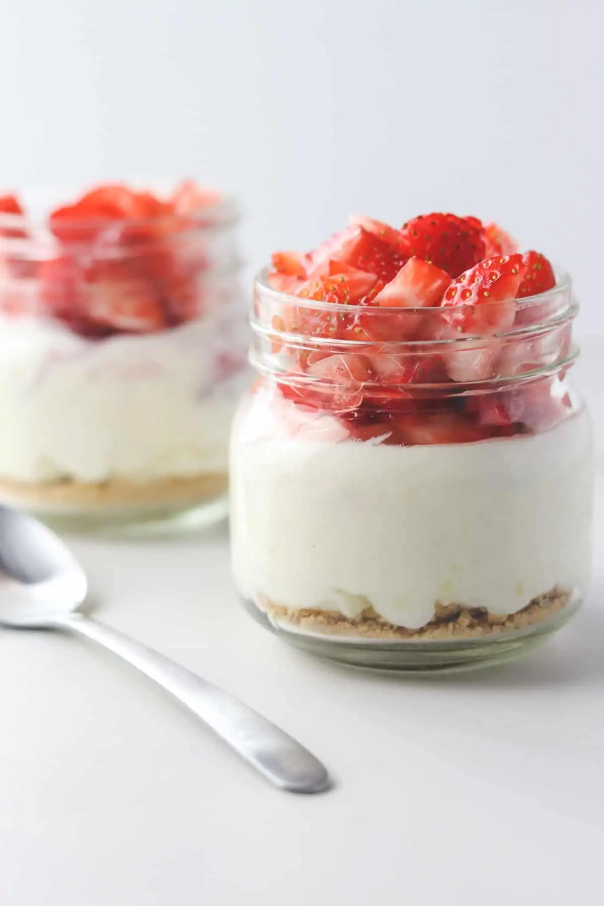 two jars of skinny cheesecake with a spoon