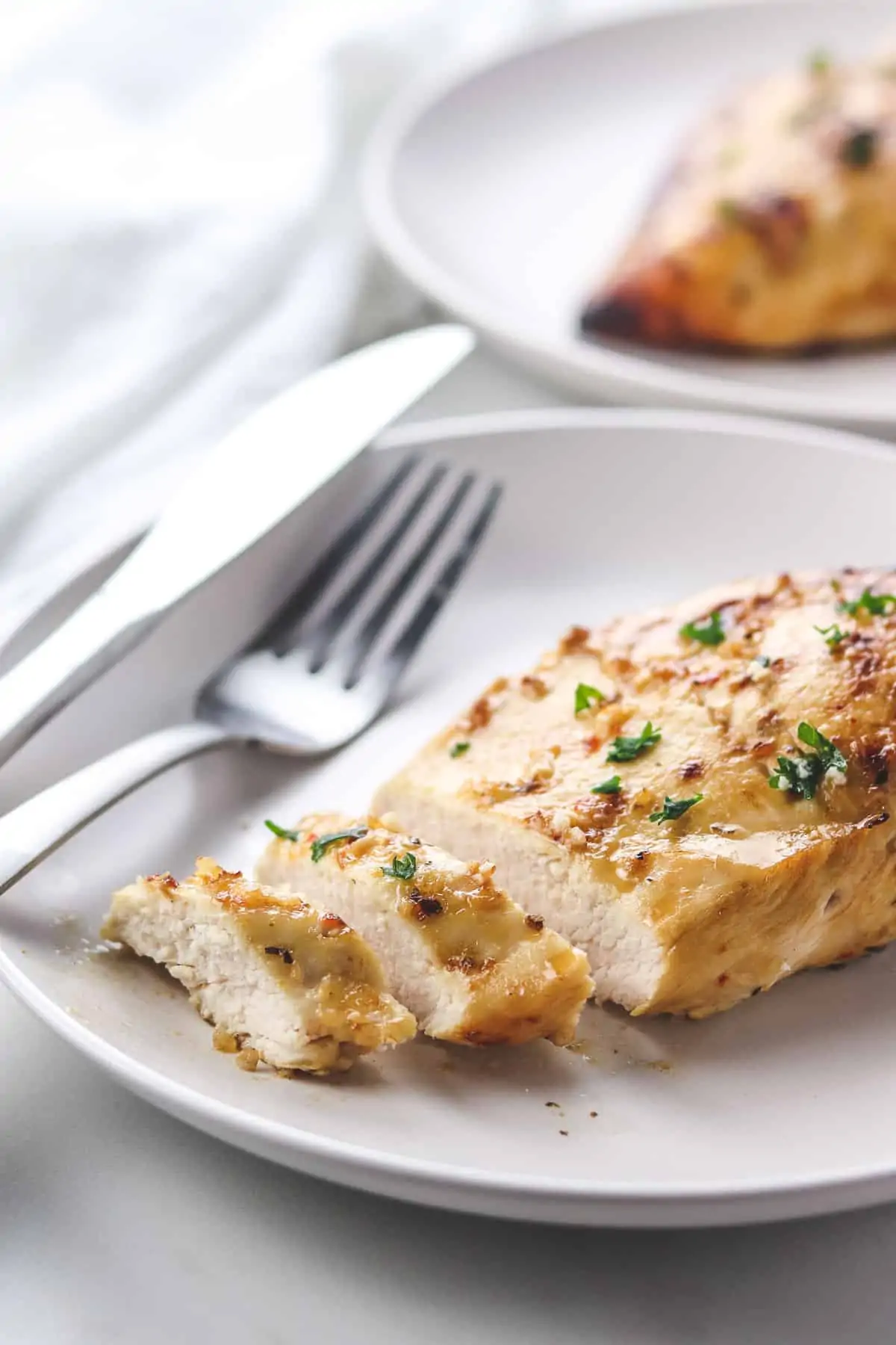 sliced air fryer chicken breast on white plate