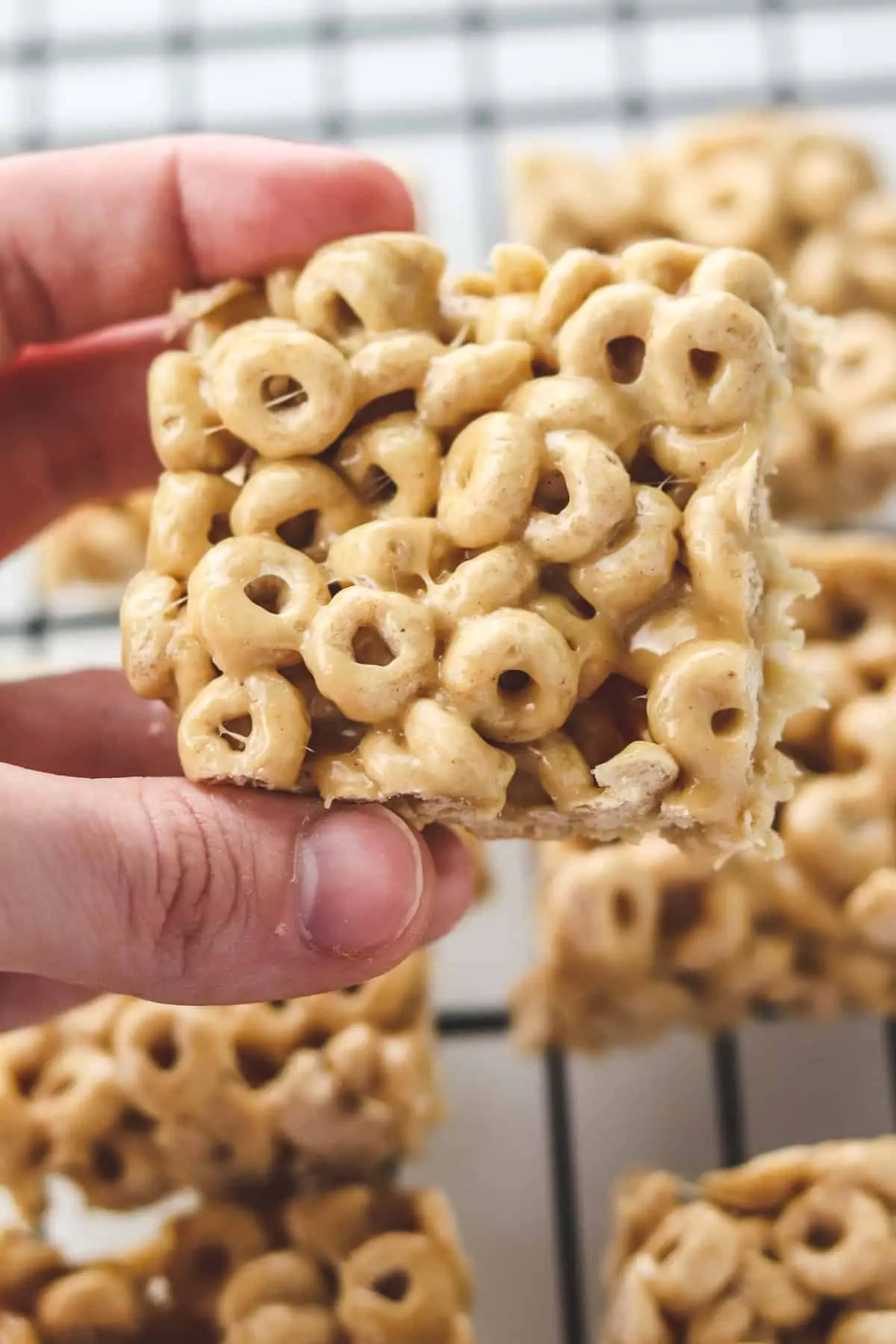 holding a peanut butter cheerio bar