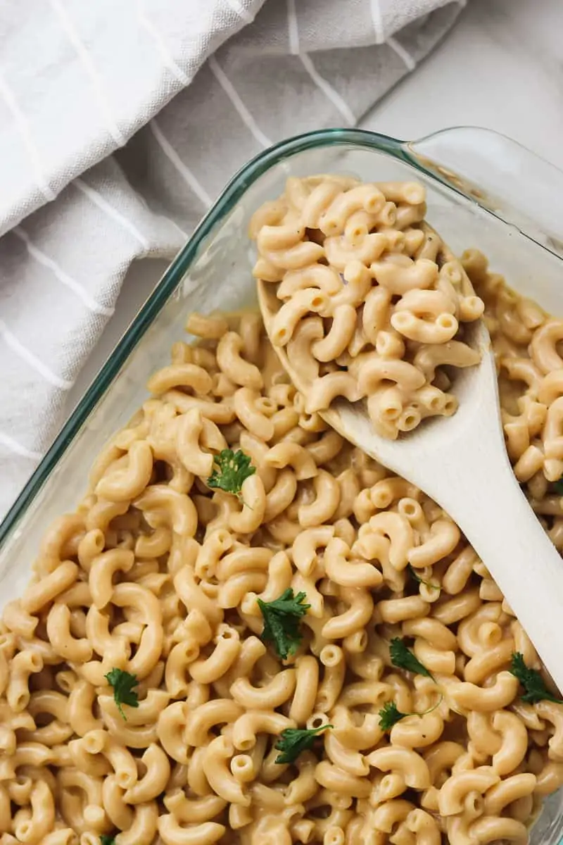 healthy macaroni and cheese scooped with a wooden spoon
