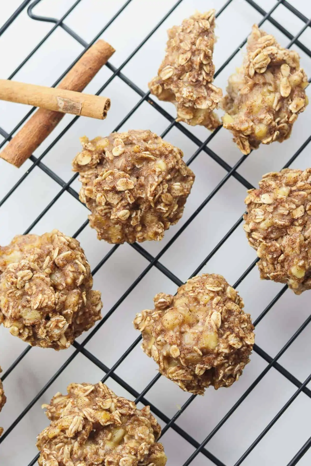 banana oat cookies on cooling rack with cinnamon sticks