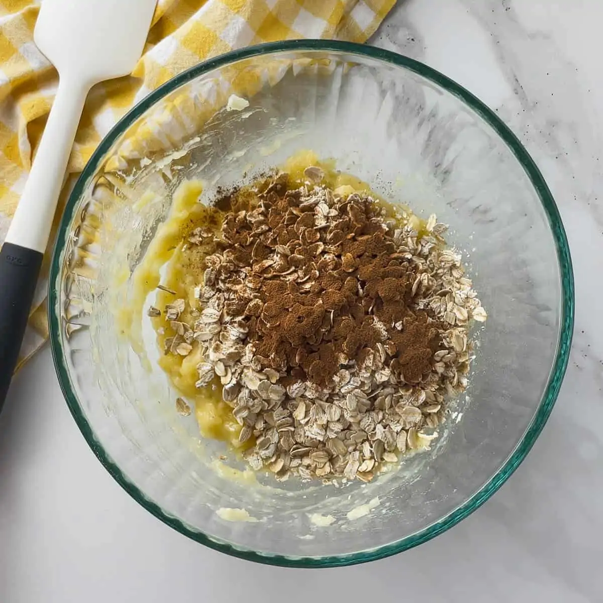 mashed banana, oatmeal, and cinnamon in mixing bowl