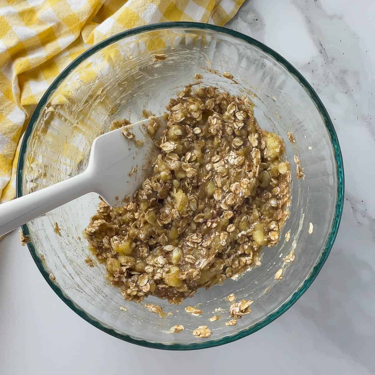 mashed banana, oatmeal, and cinnamon combined in mixing bowl