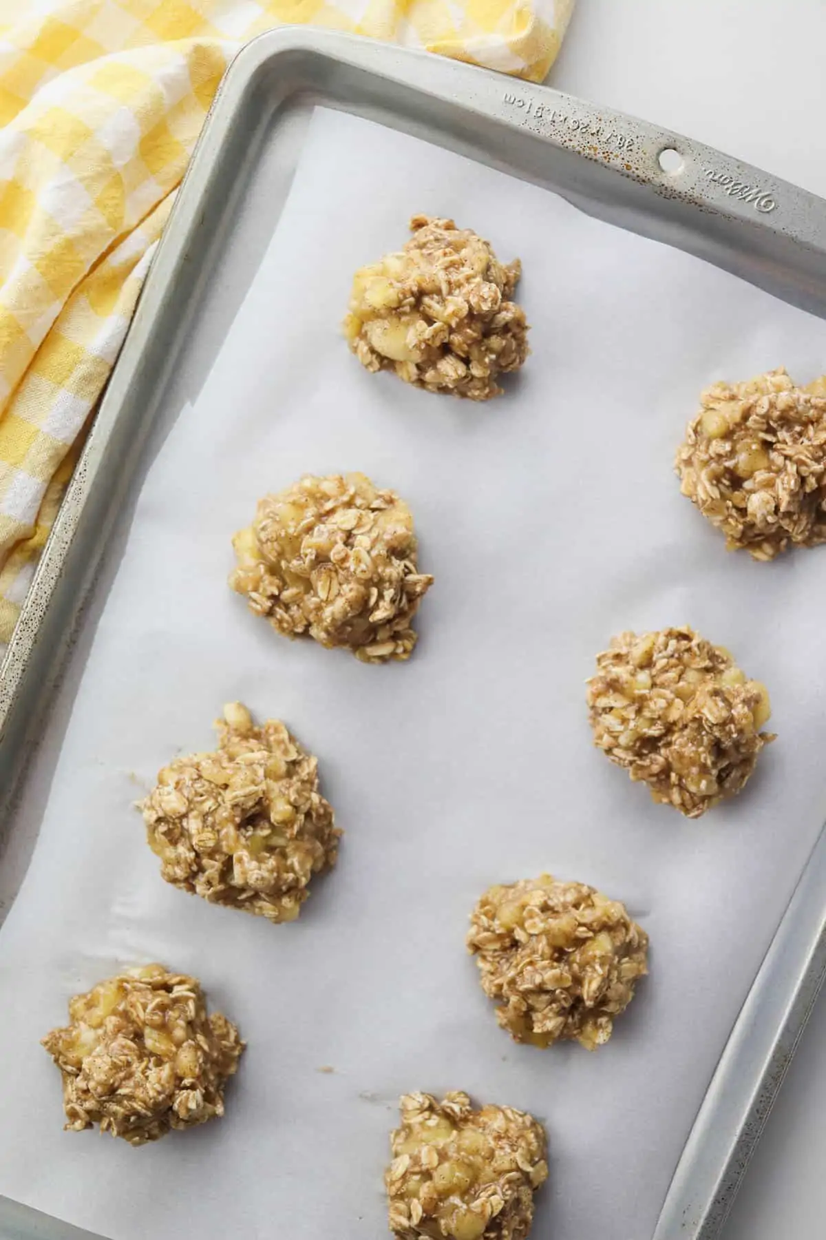 banana oatmeal cookies on a cookie sheet with yellow towel