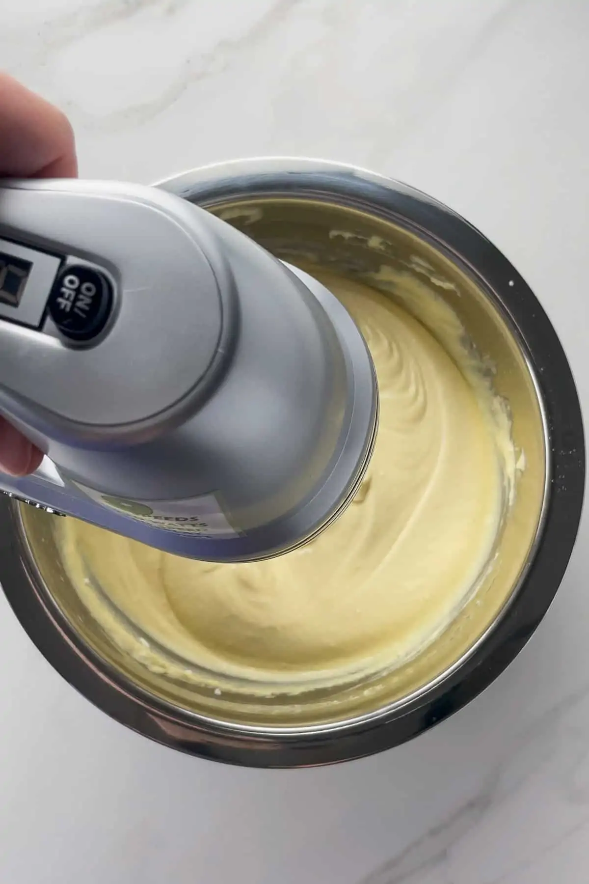 using a mixer to beat yellow cake batter