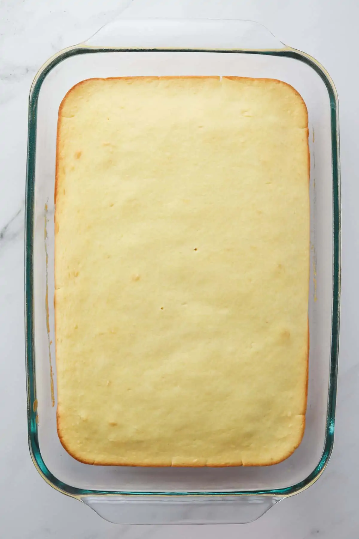 baked greek yogurt cake in a glass pan