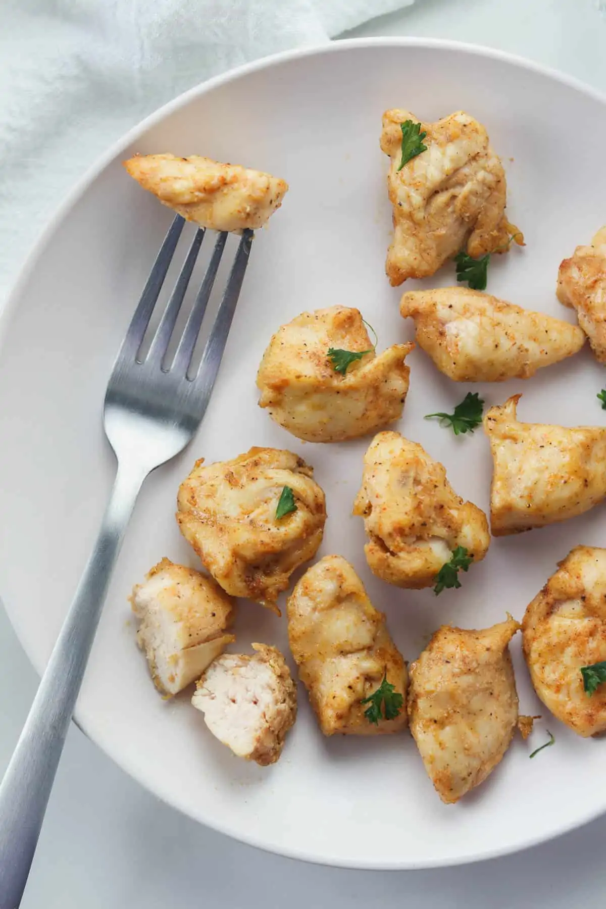 white plate of air fryer rotisserie chicken bites