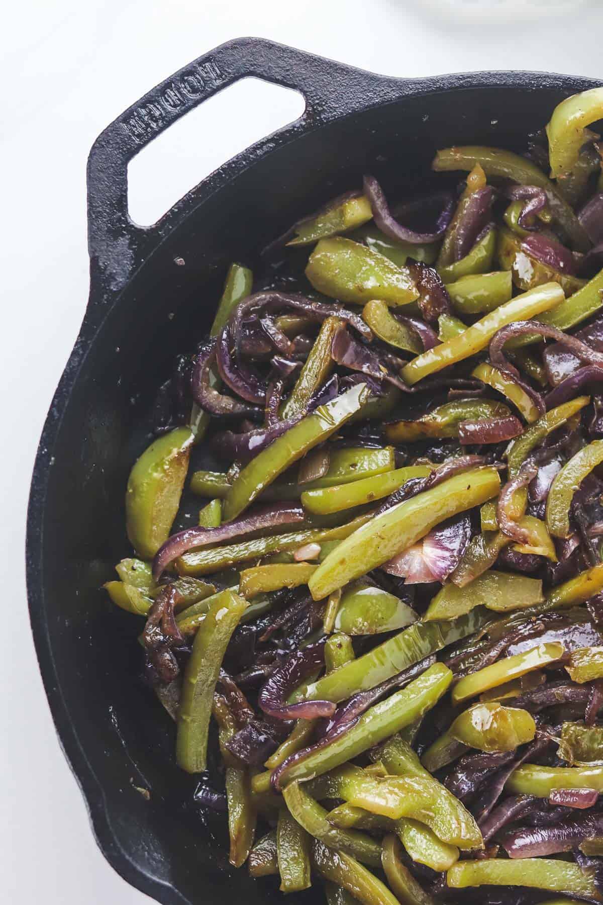 fajita peppers and onions in a cast iron skillet