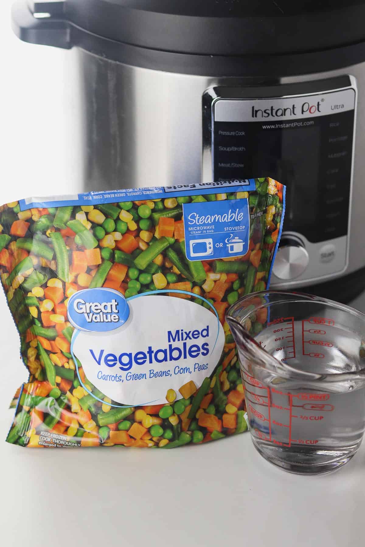 frozen mixed vegetables, cup of water, and instant pot