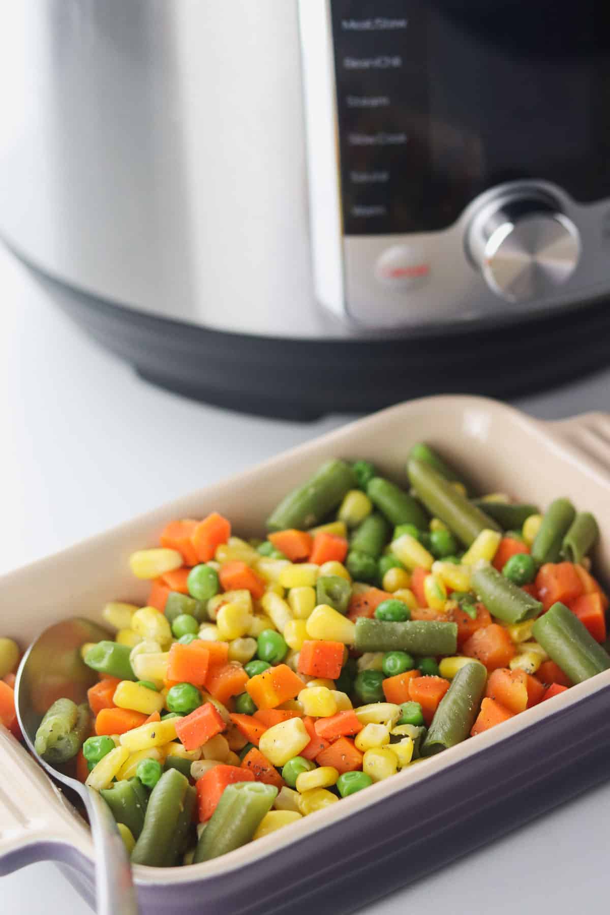 dish of mixed vegetables in front of the instant pot